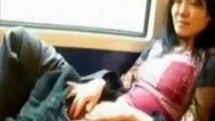 Asian milf rubs her clit on a train.